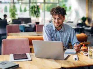 happy man looking at computer